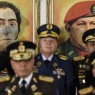 Portraits of the late Simon Bolivar and Hugo Chavez hang as Vladimir Padrino Lopez, Venezuela's defense minister, bottom left, speaks during a press conference accompanied by the military high command at the Ministry of Defense in Caracas, Venezuela, on Thursday, Jan. 24, 2019. Venezuela's top military officials took to the airwaves on Thursday to swear their support to embattled President??Nicolas Maduro??after the U.S. and a dozen other nations recognized his main political rival as the rightful head of state. Photographer: Carlos Becerra/Bloomberg via Getty Images