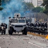 23 January 2019, Venezuela, Caracas: Security forces are standing in a street full of stones after clashes with demonstrators. Thousands of people took to the streets against the government of President Maduro. At a rally in Caracas, Venezuelan parliamentary leader Guaido declared himself interim president and openly challenged head of state Maduro. Photo: Rayner Pena/dpa (Photo by Rayner Pena/picture alliance via Getty Images)